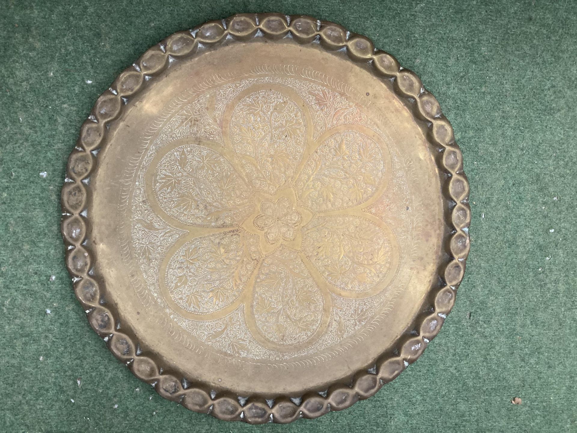 A LARGE INDIAN BRASS ENGRAVED CHARGER DIAMETER 52CM