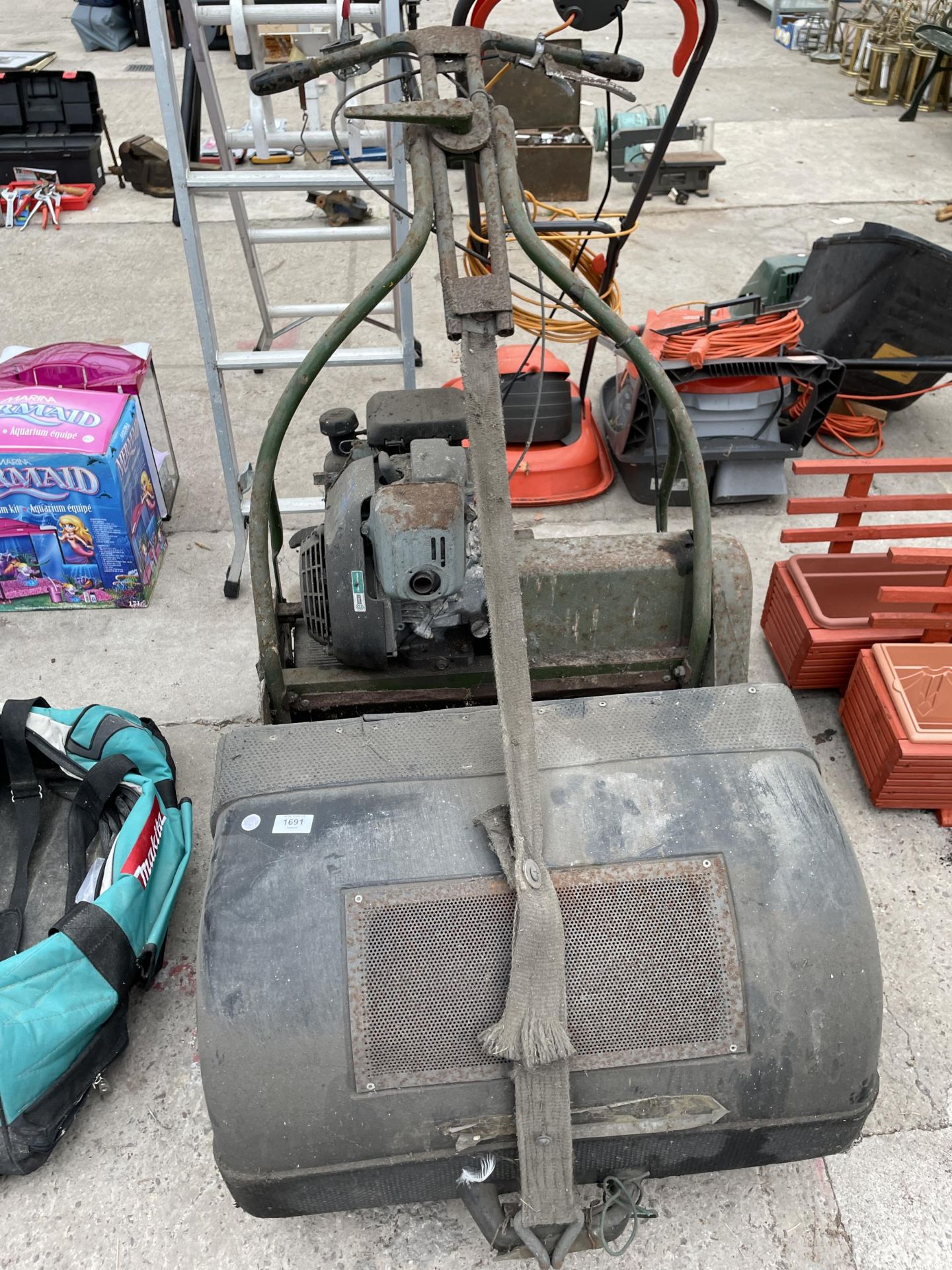A LARGE VINTAGE CYLINDER MOWER COMPLETE WITH HONDA ENGINE AND GRASS BOX