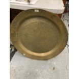 A VERY LARGE DECORATIVE BRASS CHARGER