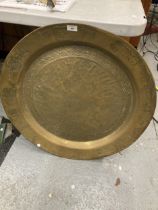 A VERY LARGE DECORATIVE BRASS CHARGER