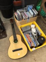 AN ASSORTMENT OF CDS AND A SMALL ACOUSTIC GUITAR