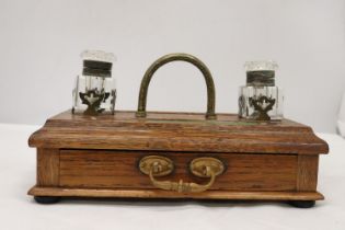 A VINTAGE OAK DESKSET WITH BRASS HANDLE AND DRAWER WITH GLASS INKWELLS