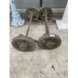 A PAIR OF VINTAGE CAST IRON RAILWAY TROLLEY AXLES AND WHEELS