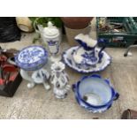 AN ASSORTMENT OF BLUE AND WHITE CERAMICS TO INCLUDE A JARDINAIRE STAND AND A JUG AND WASH BOWL SET