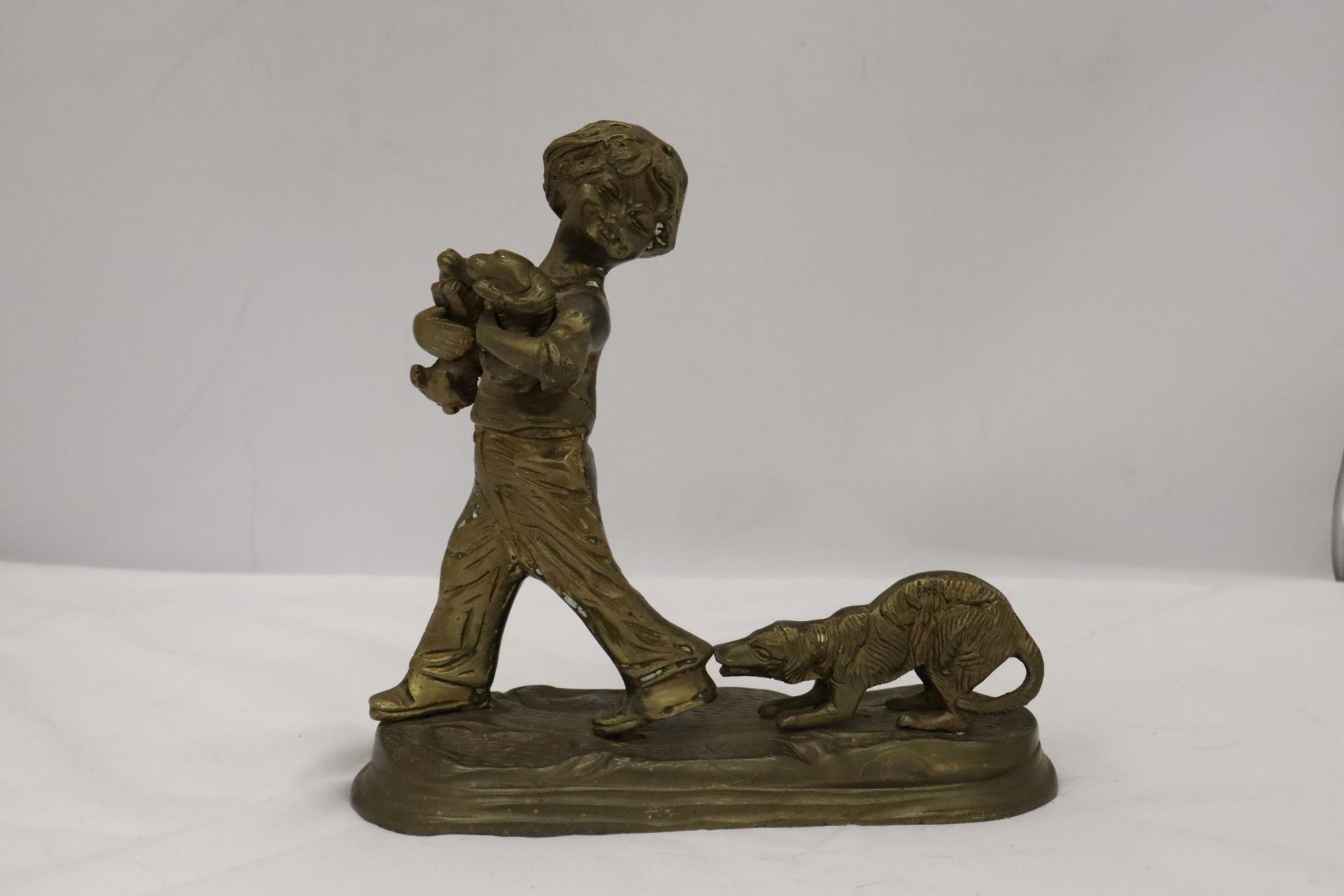 A BRASS FIGURE OF A BOY WITH PUPPY DOGS, HEIGHT 20CM, WIDTH 20CM