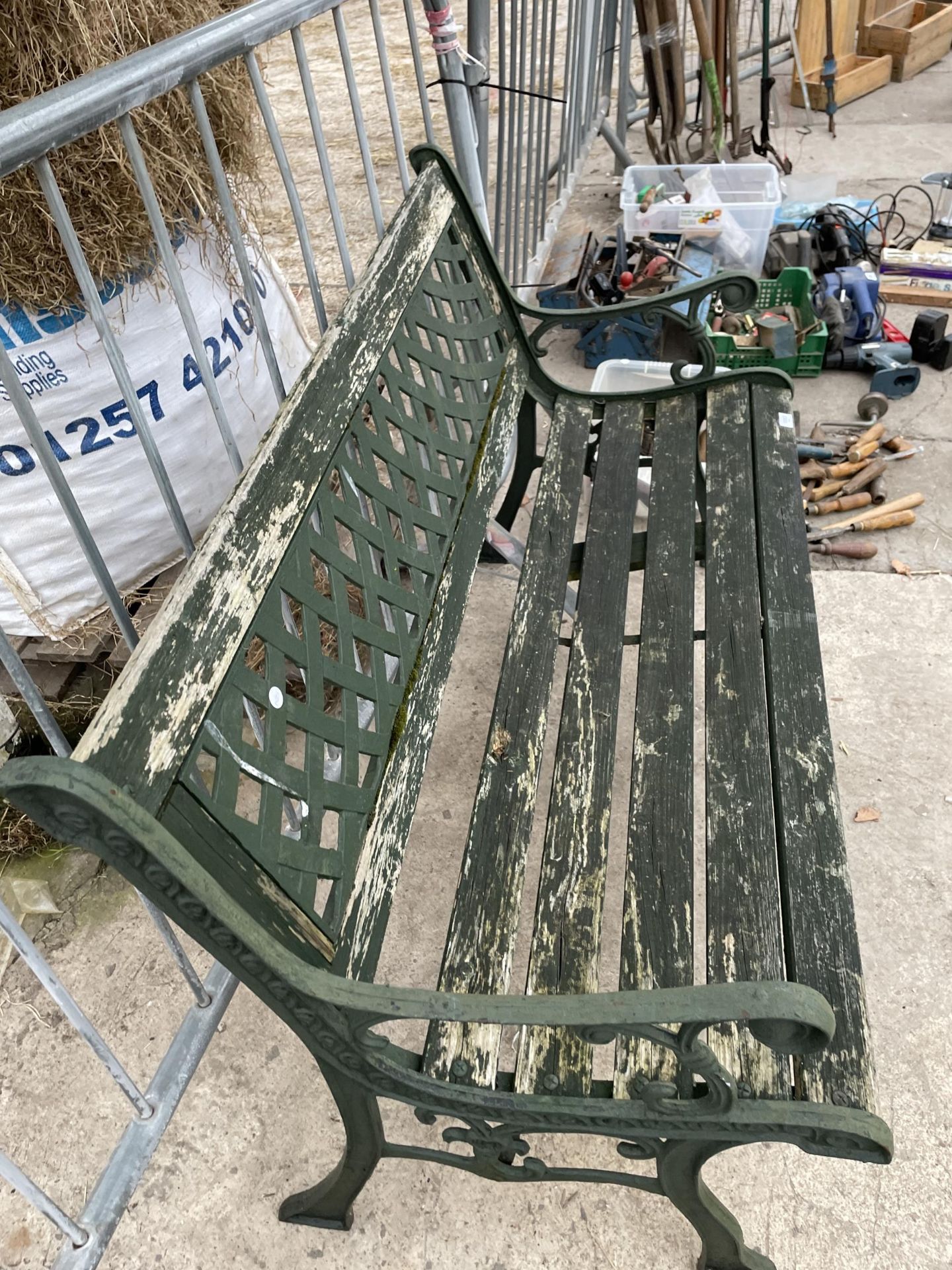 A WOOD SLATTED GARDEN BENCH WITH DECORATIVE CAST ENDS AND BACK - Image 2 of 2