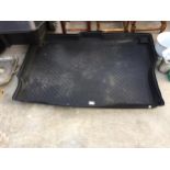 A LARGE PLASTIC CAR BOOT LINER