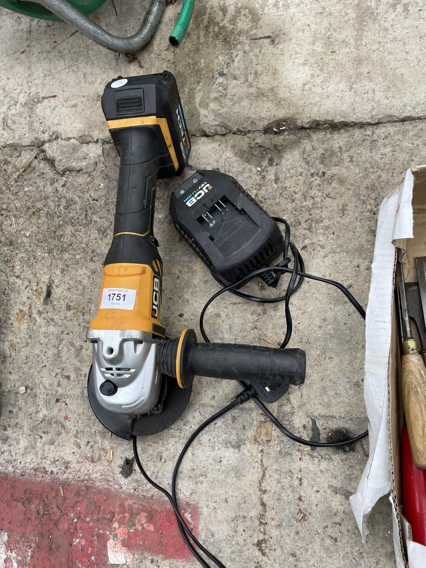 A BATTERY POWERED JCB ANGLE GRINDER WITH CHARGER