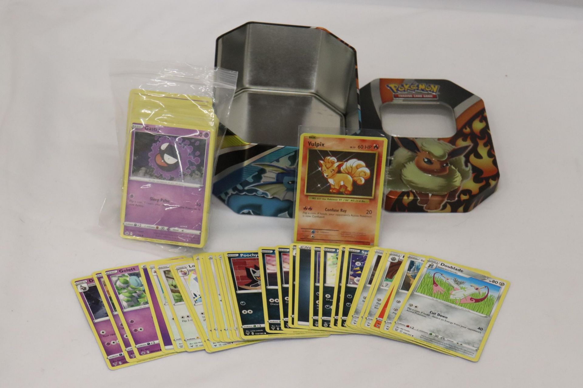 A POKEMON COLLECTORS TIN FULL OF 100+ POKEMON CARDS