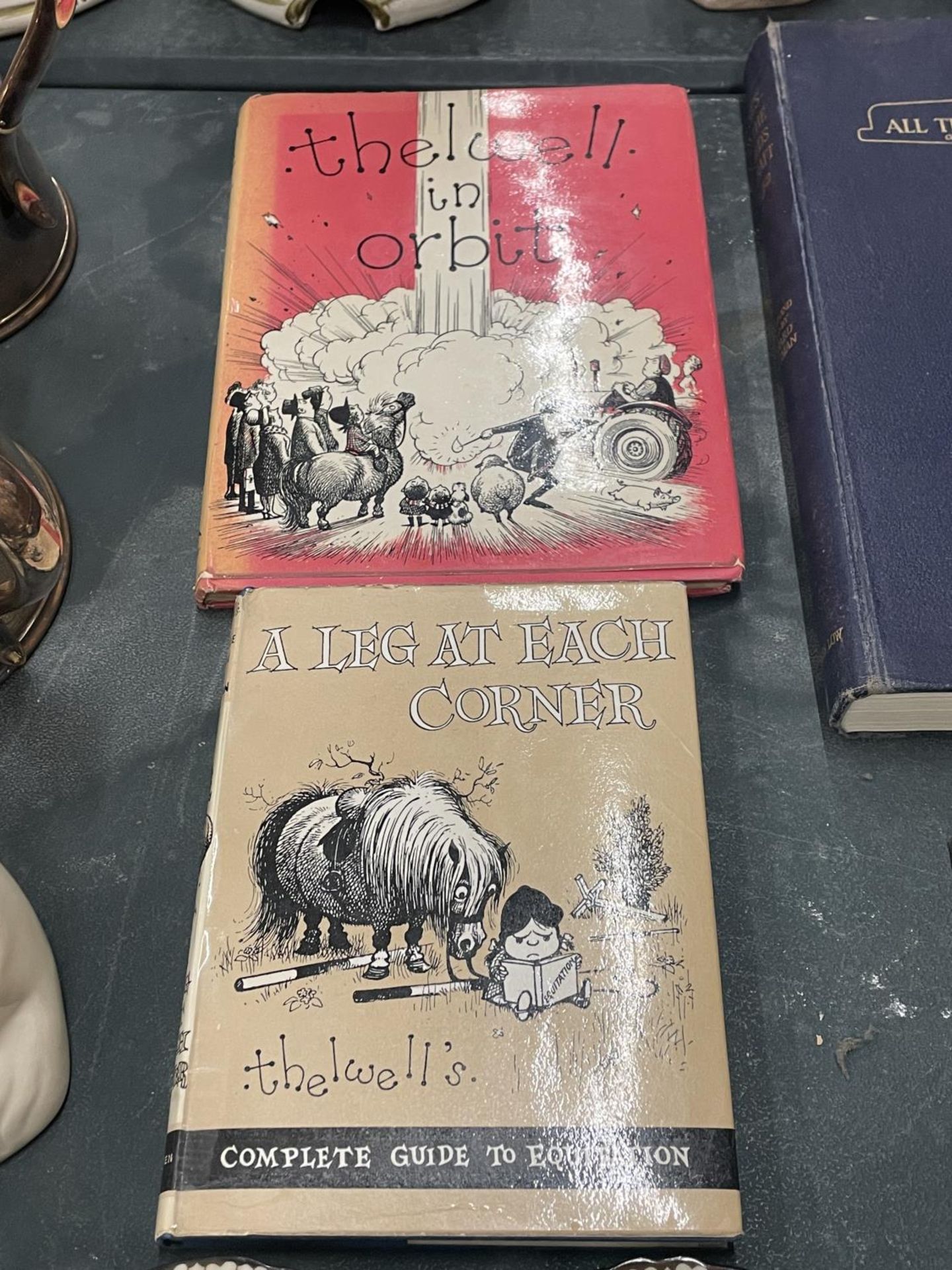TWO VINTAGE THELWELL HARDBACKBOOKS TO INCLUDE 'A LEG AT EACH CORNER' AND 'THELWELL IN ORBIT'