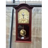 A WOODEN CASED TEMPUS CHIMING WALL CLOCK