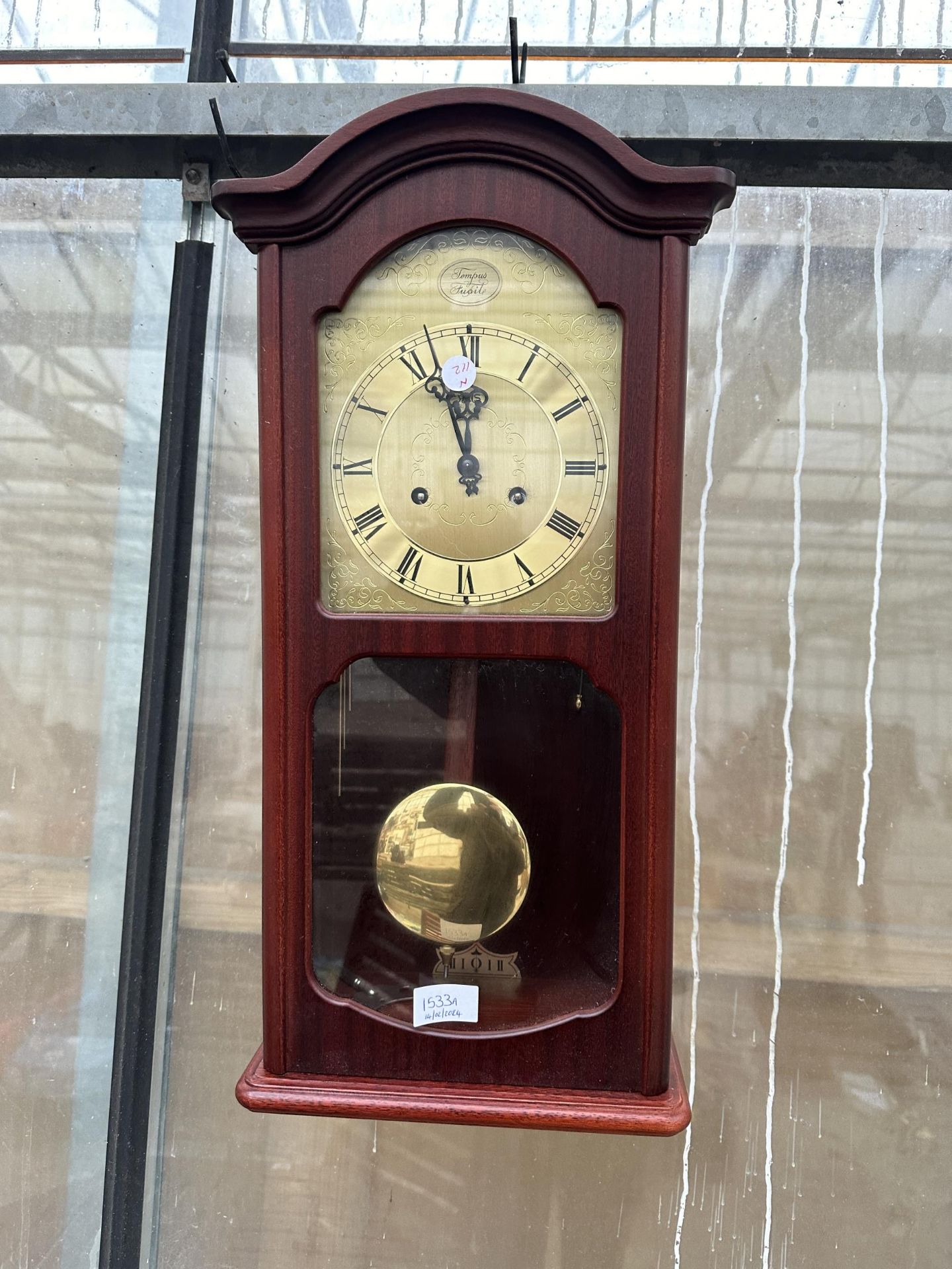 A WOODEN CASED TEMPUS CHIMING WALL CLOCK