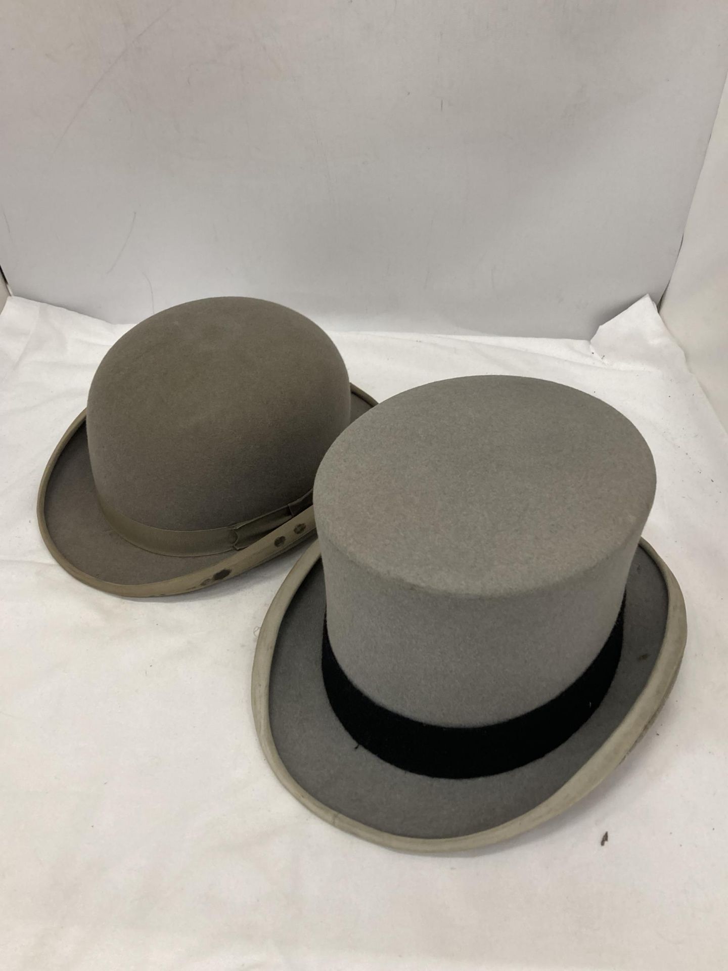 TWO GREY VINTAGE HATS TO INCLUDE A BOWLER DUNN & CO AND A TOP HAT