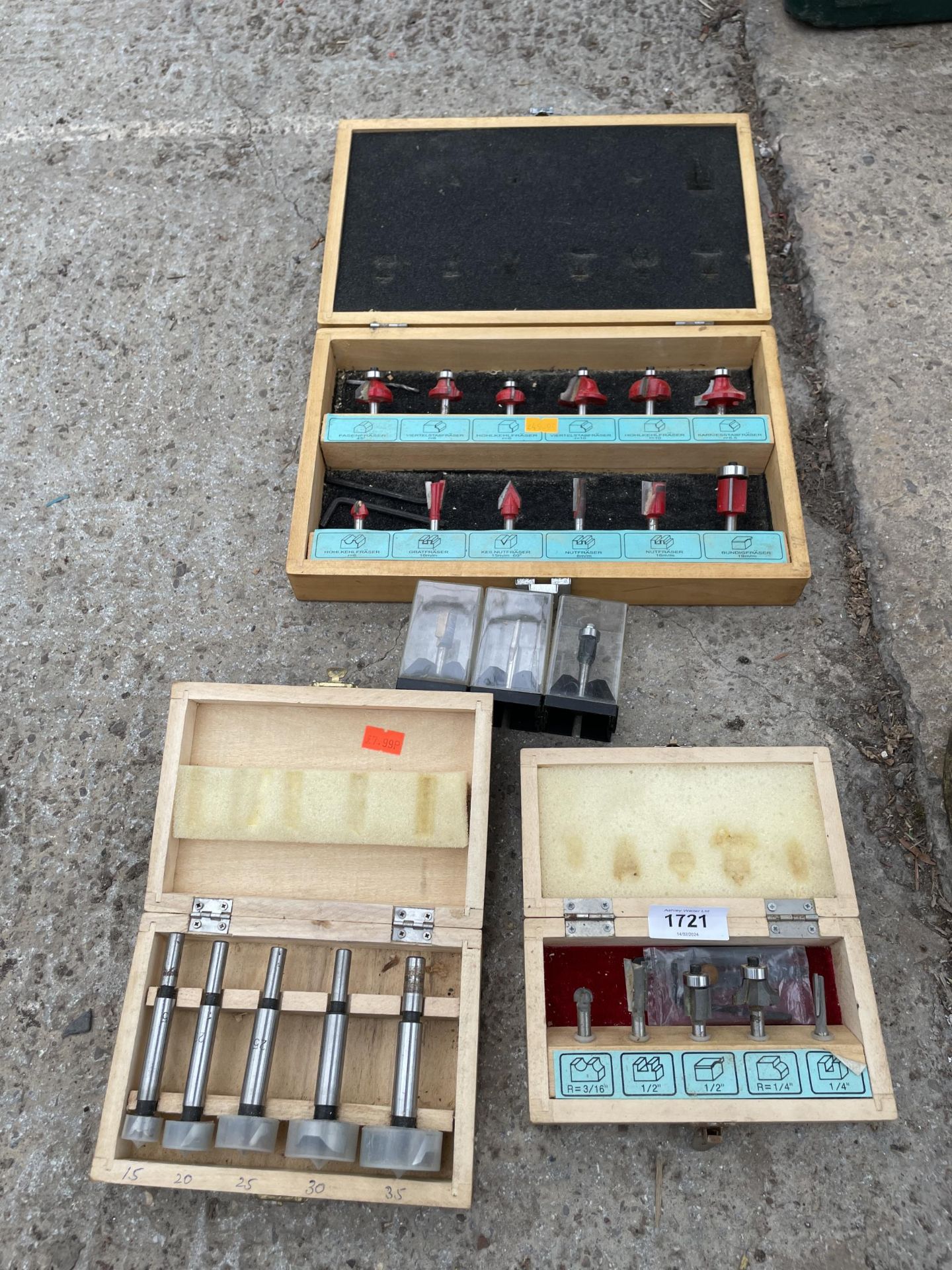 AN ASSORTMENT OF CASED ROUTER BITS