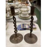 A PAIR OF TWISTED BRONZE CANDLESTICKS