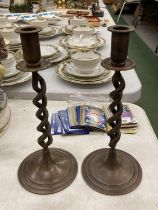 A PAIR OF TWISTED BRONZE CANDLESTICKS