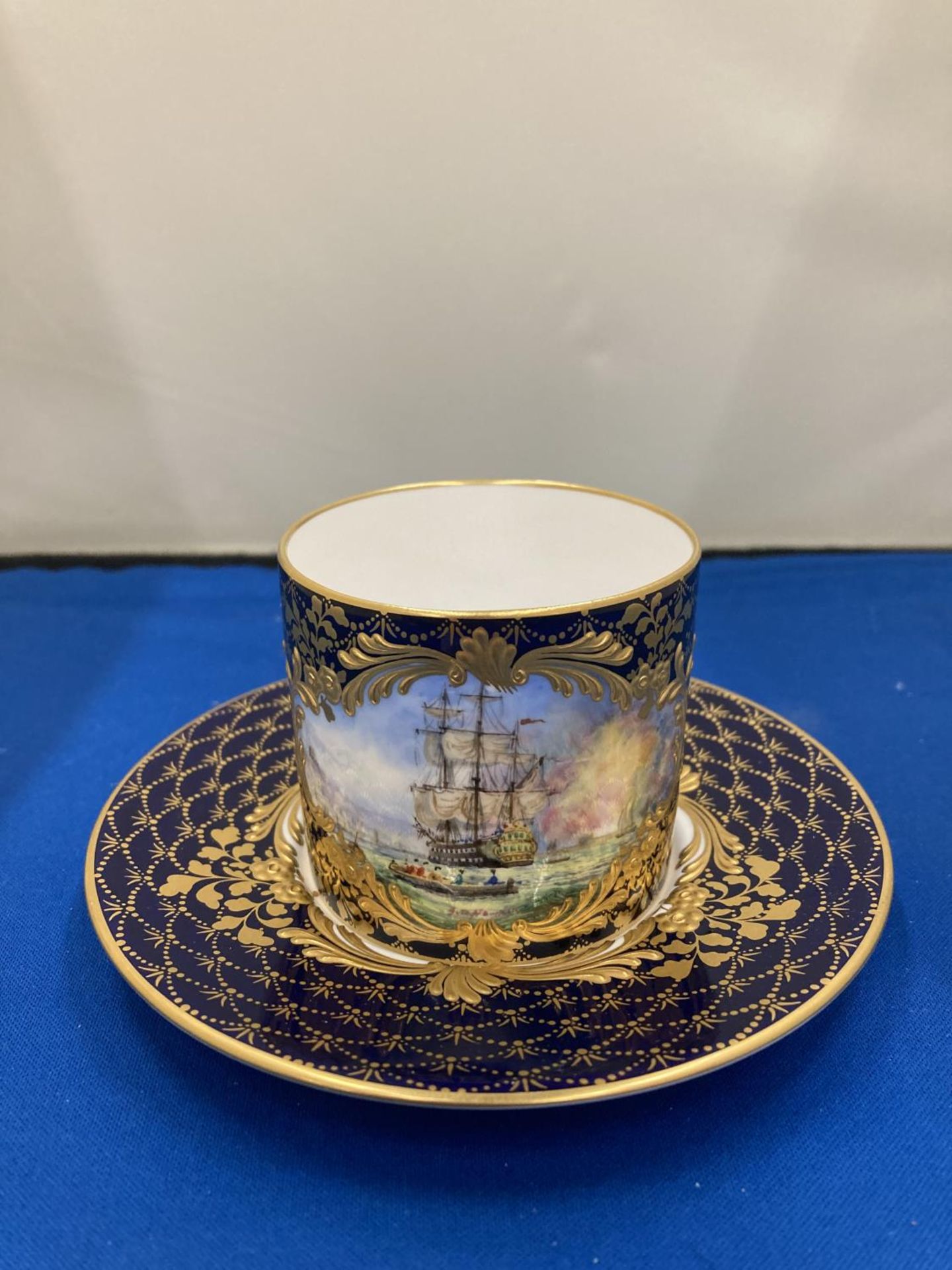A LYNTON PORCELAIN HAND PAINTED COFFEE CAN AND SAUCER, BRITISH MAN OF WARSHIPS ON THE HIGH SEAS,