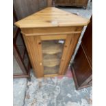 A GLAZED PINE CORNER CUPBOARD - 23" WIDE