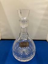 A GLASS DECANTER WITH A HALLMARKED BIRMINGHAM SILVER WHISKY LABEL