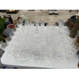 A LARGE QUANTITY OF CUT GLASS WARE TO INCLUDE WINE GLASSES, WHISKEY GLASSES AND BRANDY BALOONS ETC