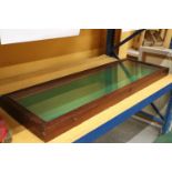 A LONG GREEN BAIZE DISPLAY CABINET 51 X 18 INCH