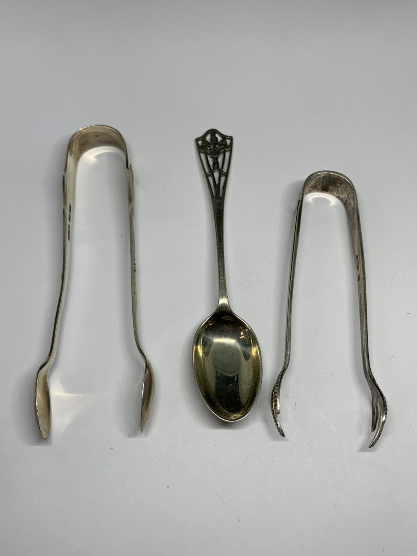 TWO HALLMARKED SHEFFIELD SUGAR TONGS AND A LONDON SPOON GROSS WEIGHT 20.7 GRAMS