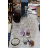 A QUANTITY OF GLASSWARE TO INCLUDE DECANTERS, GLASSES, BOWLS, A SCENT BOTTLE, PAPERWEIGHT, ETC