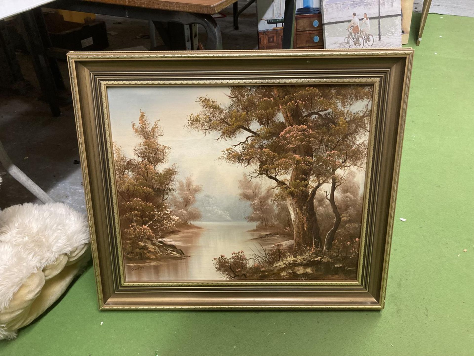 A GILT FRAMED OIL ON CANVAS OF A LAKE SCENE SIGNED G WATTS 73CM X 25CM