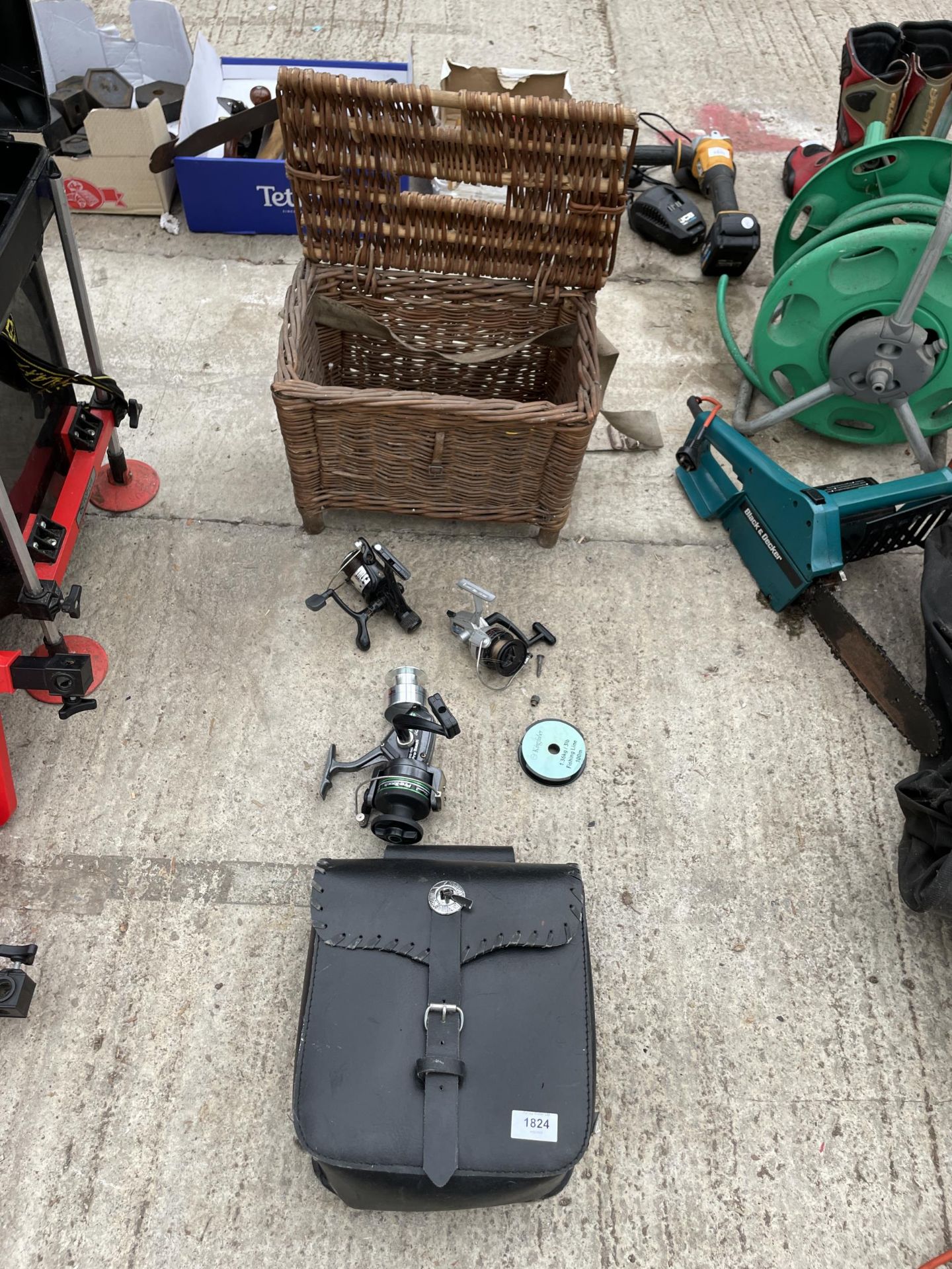 AN ASSORTMENT OF FISHING TACKLE TO INCLUDE A WICKER TACKLE BOX AND THREE REELS ETC