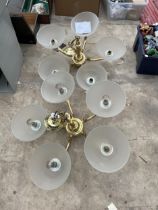 A PAIR OF HEAVY BRASS FIVE BRANCH CEILING LIGHT FITTINGS WITH GLASS SHADES