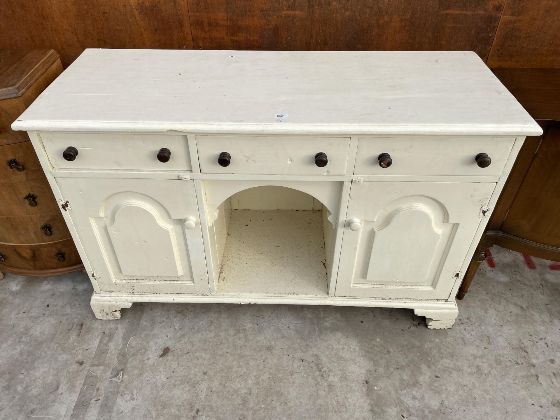 A VICTORIAN STYLE PINE KITCHEN DRESSER BASE ENCASING THREE DRAWERS, TWO CUPBOARDS AND AN OPEN