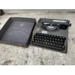 A VINTAGE HERME BABY TYPEWRITER WITH CARRY CASE