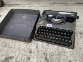 A VINTAGE HERME BABY TYPEWRITER WITH CARRY CASE