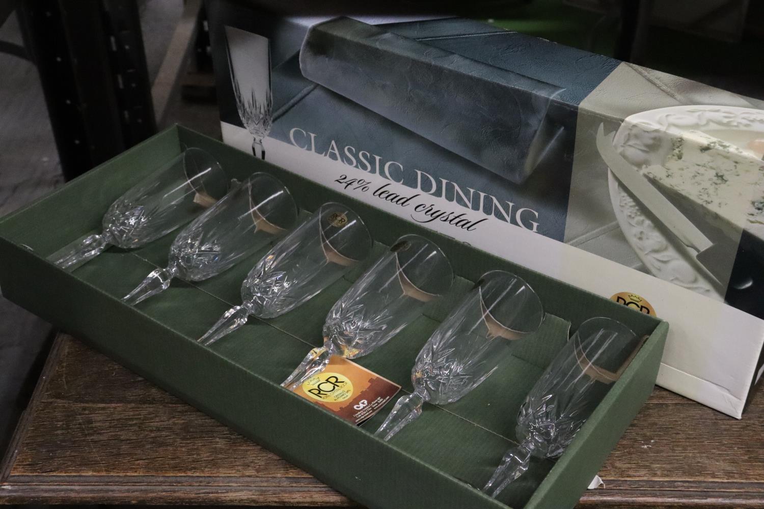 A BOXED SET OF 6 LEAD CRYSTAL CHAMPAGNE FLUTES