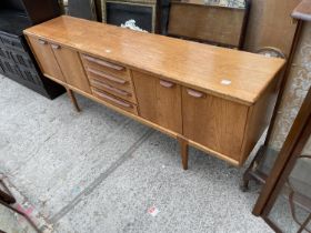 A YOUNGER RETRO TEAK SIDEBOARD ENCLOSING FOUR DRAWERS AND FOUR CUPBOARDS, 84" WIDE