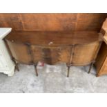 A REGANCY STYLE MAHOGANY STONGBOW SIDEBOARD ENCASING TWO CUPBOARDS AND THREE DRAWERS 66" WIDE