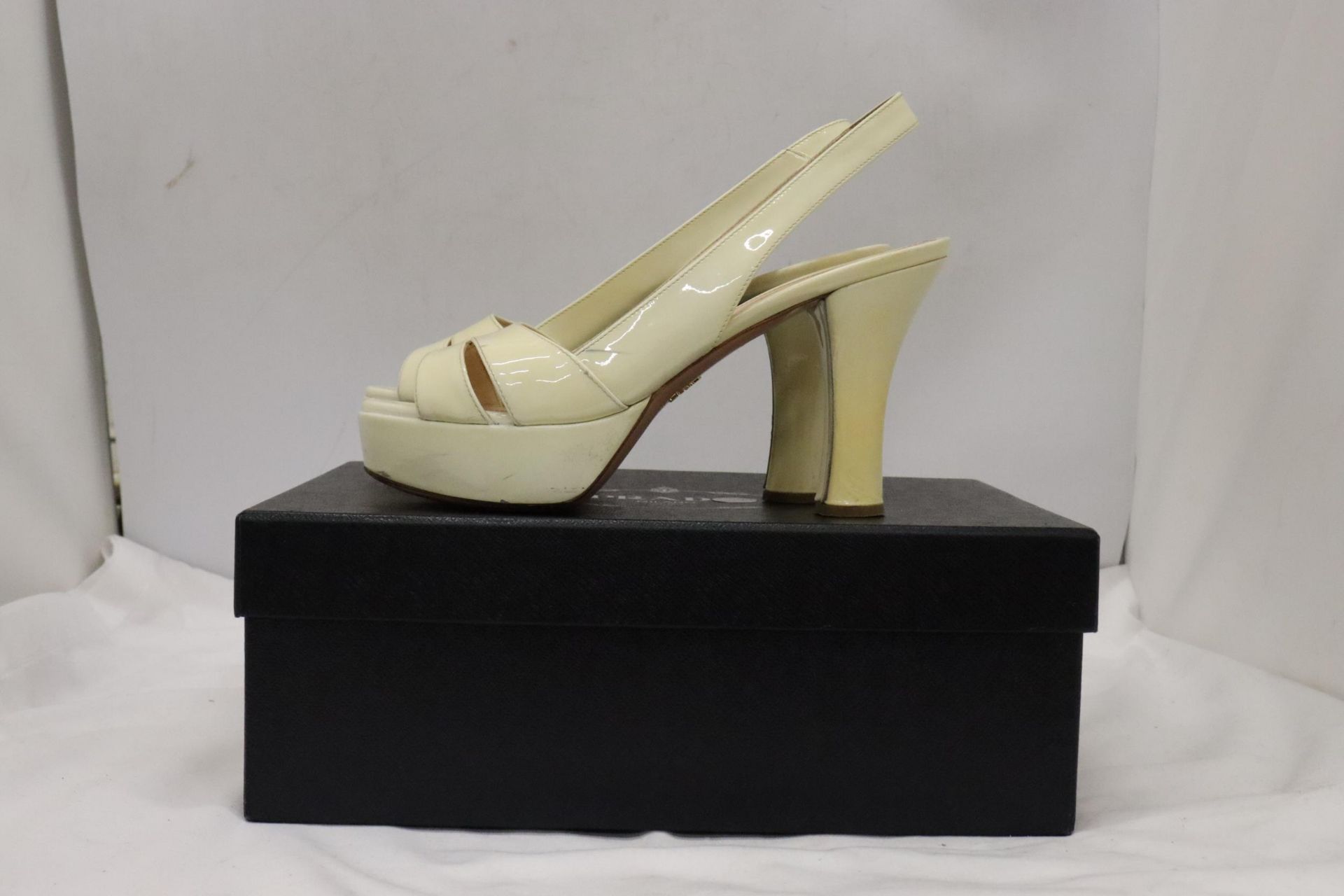 A PAIR OF CREAM HIGH HEELED SHOES, MARKED WITH A GOLD COLOURED 'PRADA' TO THE UNDERSIDE, IN A BOX - Image 7 of 7