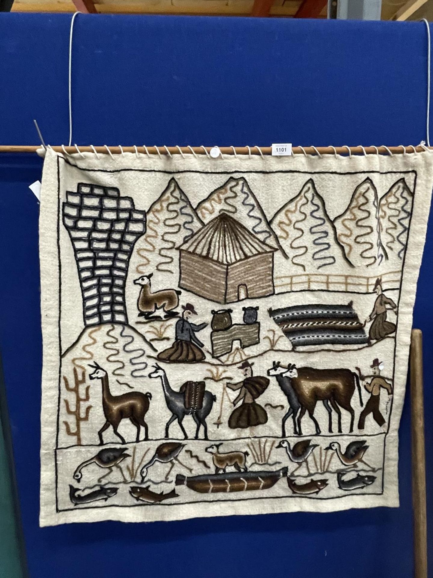 A NAIVE WOOLWORK WALL HANGING WITH ANIMALS, FIGURES AND MOUNTAINS, APPROX 84CM X 80CM