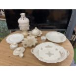 A LARGE COLLECTION OF CREAMWARE TO INCLUDE A LIDDED URN WITH CHERUBS, DISHES, PLATES, MINIATURE