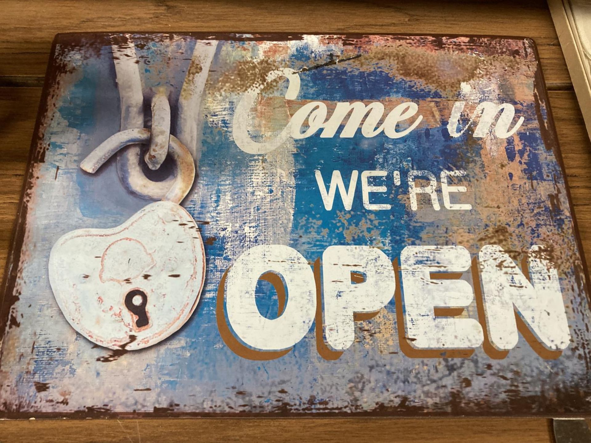 A TIN SIGN COME IN WE'RE OPEN