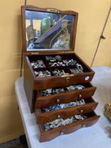 A THREE DRAWER JEWELLERY CHEST WITH HINGED TOP, MIRROR AND COSTUME JEWELLERY CONTENTS