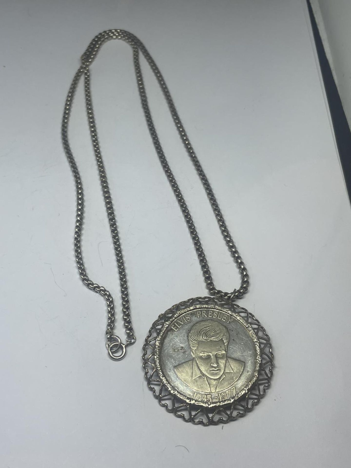 A SILVER ELVIS PRESLEY COIN NECKLACE