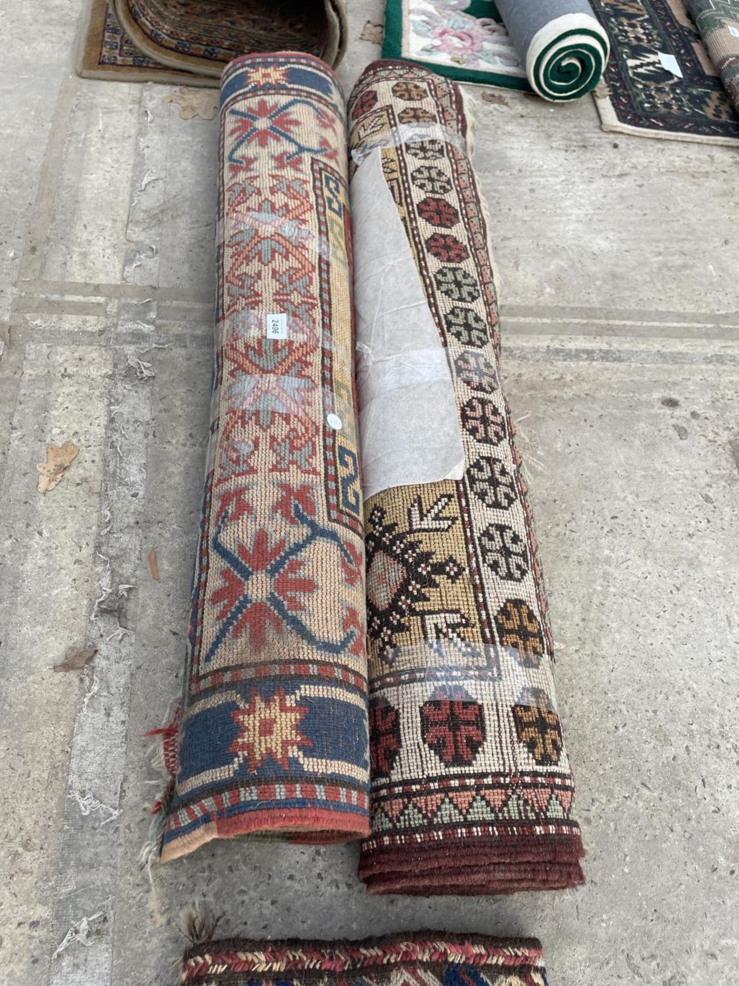 TWO SMALL PATERNED FRINGED RUGS