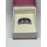 A SILVER DRESS RING IN A PRESENTATION BOX