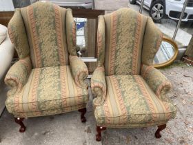 A PAIR OF GEORGIAN STYLE WINGED EASY CHAIRS ON FRONT CABRIOLE LEGS WITH BALL AND CLAW FEET
