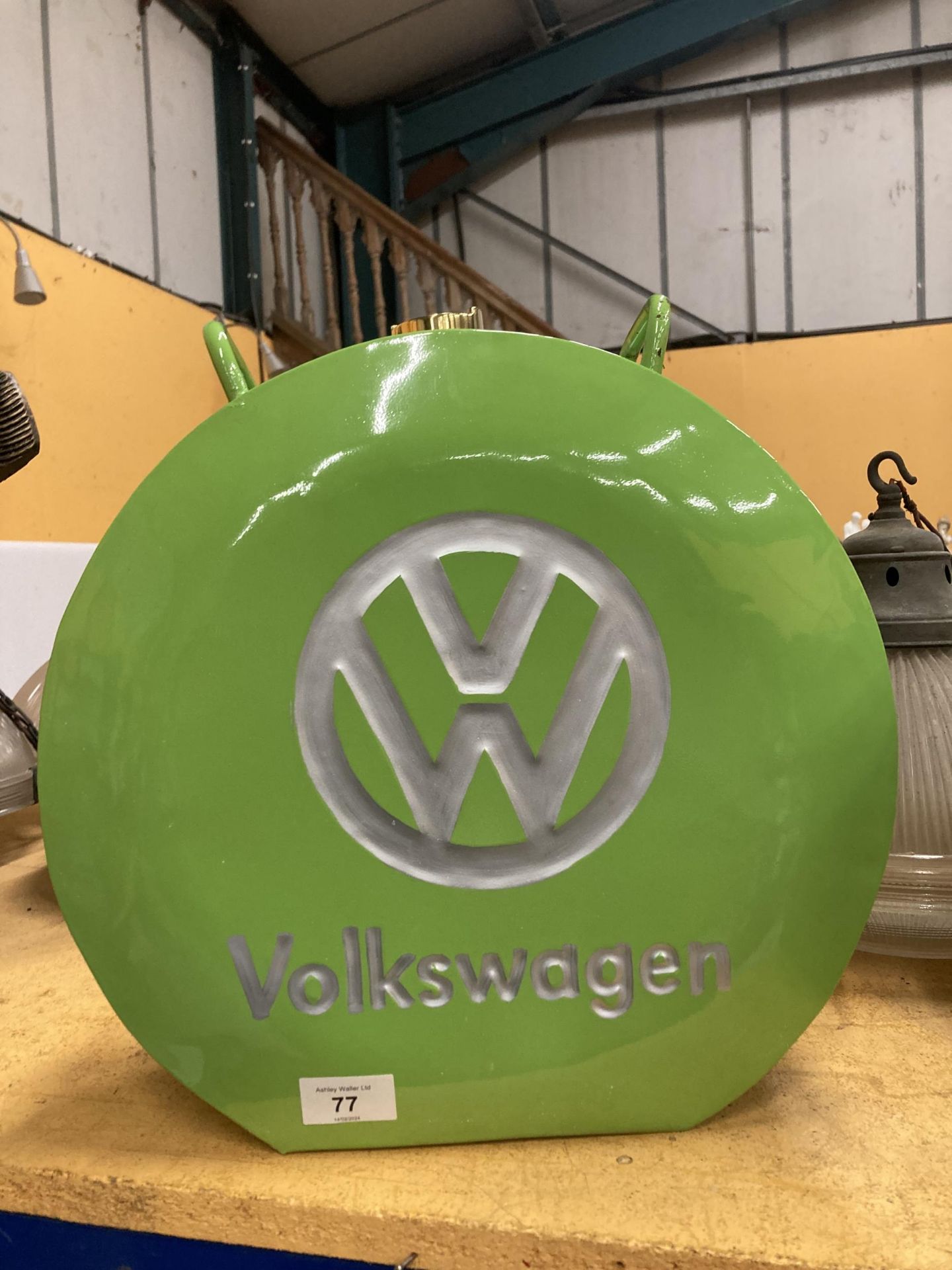 A GREEN VOLKSWAGEN FUEL CAN WITH BRASS STOPPER