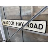 A LARGE METAL 'PEACOCK HAY ROAD' ROAD SIGN