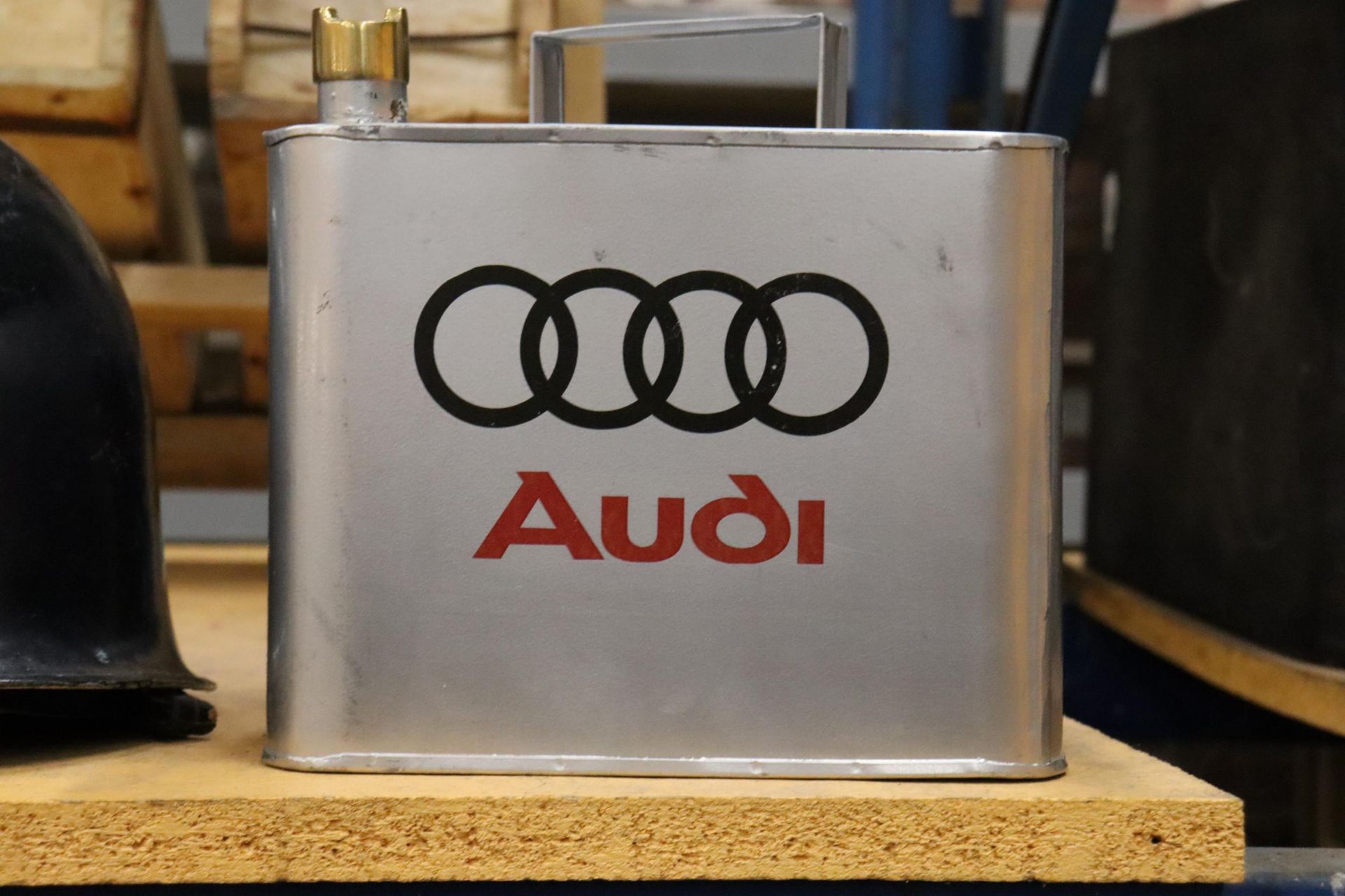 A SILVER AUDI OIL CAN