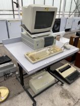 A COMPUTER DESK AND AN ASSORTMENT OF RETRO COMPUTER ITEMS TO INCLUDE A MONITOR AND TOWER ETC