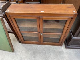 A WAXED PINE TWO-DOOR WALL CABINET, 35" WIDE
